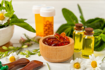 Alternative medicine herbal capsule organic drug on wooden background.Assortment of herbal and...