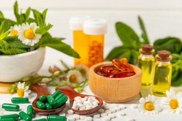 Alternative medicine herbal capsule organic drug on wooden background.Assortment of herbal and...