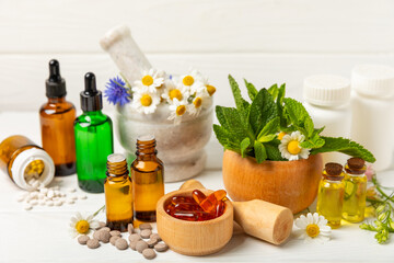 Alternative medicine herbal capsule organic drug on wooden background.Assortment of herbal and...