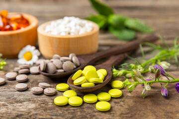 Alternative medicine herbal capsule organic drug on wooden background.Assortment of herbal and tablets,vitamins and dietary supplements.medicinal and Healing herbs.natural supplements for healthy life