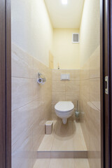 Modern Compact Bathroom with Beige Tiles and Minimalist Design Elements