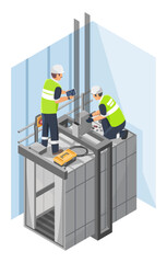 Technician installing elevator system on top of lift shaft with tools and control panel inside high rise building for maintenance and safety inspection purposes
