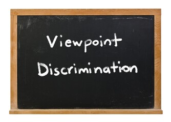 Obraz premium Viewpoint discrimination written in white chalk on a black chalkboard with a wooden frame