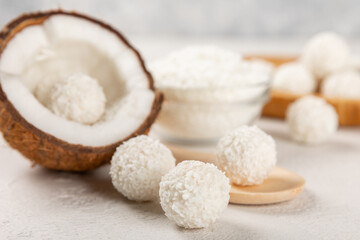 Coconut candies on a wooden background. Candies with chocolate, almonds and delicate butter cream. Coconut flakes. tasty sweets.Tasty ball-shaped chocolate candies.Dessert. Space for text.copy space