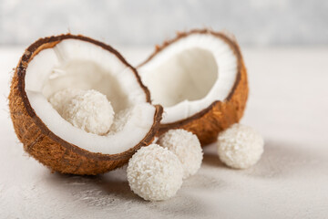 Coconut candies on a wooden background. Candies with chocolate, almonds and delicate butter cream. Coconut flakes. tasty sweets.Tasty ball-shaped chocolate candies.Dessert. Space for text.copy space