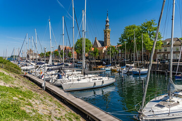 Veere, province of Zeeland, The Netherlands – The old town and the marina with the historic town hall in the background