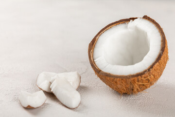 Set of fresh whole and half coconuts and slices on wooden background. Coconut flakes. Vegan. Tropical nut, fruit. Place for text. Copy space.