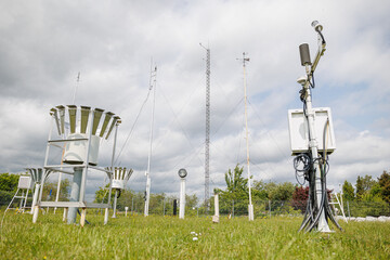 Outdoor weather station with various meteorological instruments and antennas for climate data collection.