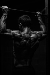 Powerful pull up silhouette in gym setting for fitness motivation and workout inspiration