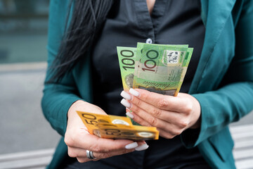 close up woman holding lot of 50 1000 new aud australian dollar. Financial concept