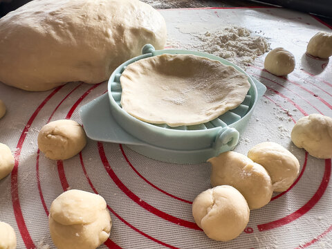 raw dough balls for dumplings kluski slaskie on flour on kitchen desk