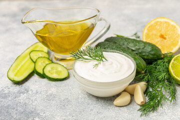 Cucumber sour cream tzatziki sauce on a wooden table.Tartar sauce. Traditional delicious appetizer. yogurt sauce. Tzatziki with ingredients cucumber, garlic,dill,lemon,mint. salad dressing.Copy space