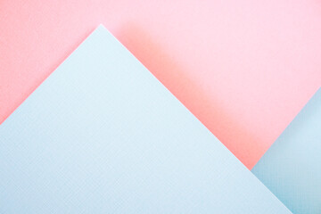 Geometric pastel color block paper background. Light blue and pastel pink colors flat lay