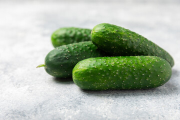 Cucumber on wooden background. Slice of cucumber on background. Fresh organic green cucumbers gherkin. Vegan. Salad ingredient. Farm vegetables. Cut vegetables with knife. Space for text. Copy space