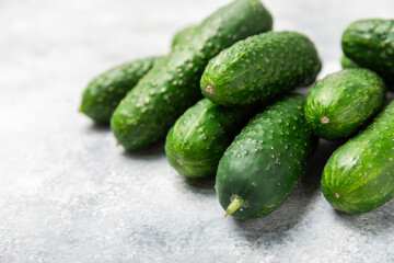 Cucumber on wooden background. Slice of cucumber on background. Fresh organic green cucumbers gherkin. Vegan. Salad ingredient. Farm vegetables. Cut vegetables with knife. Space for text. Copy space