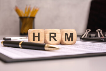 HRM concept with wooden cubes on office desk