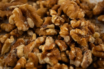 This inviting close-up captures a pile of fresh walnut halves and pieces, exuding a sense of natural goodness and healthy indulgence. Perfect for baking, healthy snacking, or superfood content