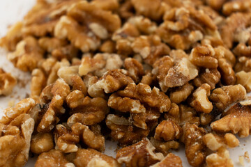 This inviting close-up captures a pile of fresh walnut halves and pieces, exuding a sense of natural goodness and healthy indulgence. Perfect for baking, healthy snacking, or superfood content