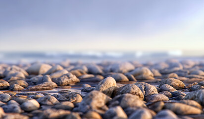 Obraz premium Natural pebbles on a tranquil beach shore and soft-focus ocean background. Serene calming scene, natural beauty. For travel, tourism, wellness, environmental background visuals, versatile designs, 3D