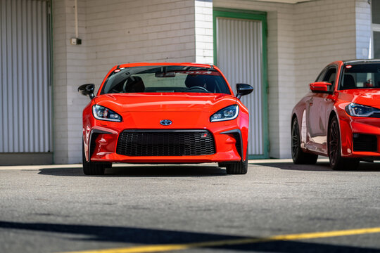 Brno, Czech Republic - October 12, 2025: Small red Toyota GR86 sports car parked outside in front of a garage. Fast Japanese two-door coupe.