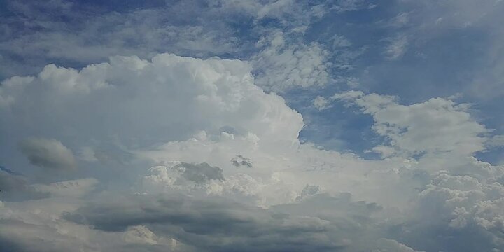 Natural blue sky with moving white clouds Cumulus, Cumulonimbus calvus, Cumulonimbus capillatus and Cumulus congestus on sunny and stormy summer weather - timelapse. Topics: cloudscape, meteorology