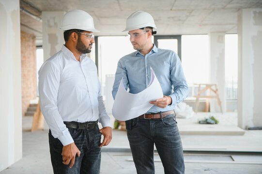 two architect engineers are walking in a constructed office building. implementation of the project