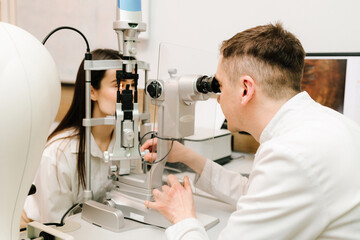 Light on eye from slit lamp for examination eyes and cornea of girl. Slit lamp eye and cornea...