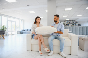 Couple chooses upholstered furniture in store