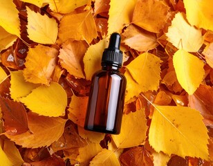 Amber dropper bottle on autumn leaves