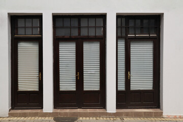 3 three Black painting wooden doors in the shop cafe salon or windows. Background for banner. Advertising. Modern construction. closed off white textile curtains. white plaster stucco exterior wall