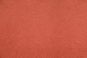 Fototapeta premium Color of the year 2024 , 13-1023 Peach Fuzz color, plain textured background. Red pink in plaster stucco cement concrete wall pattern texture backdrop. front view