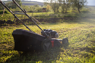 mowing the grass with a lawn mower. Garden work concept background.