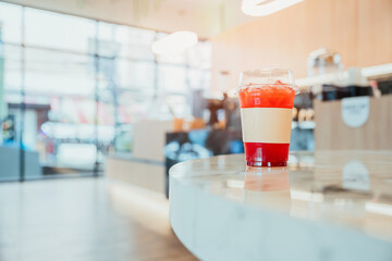 Colorful Layered Drink on Marble Counter in Modern Cafe Interior with Bright Atmosphere and Soft Lighting