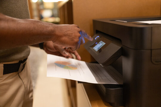 Man using printer in a modern coworking space