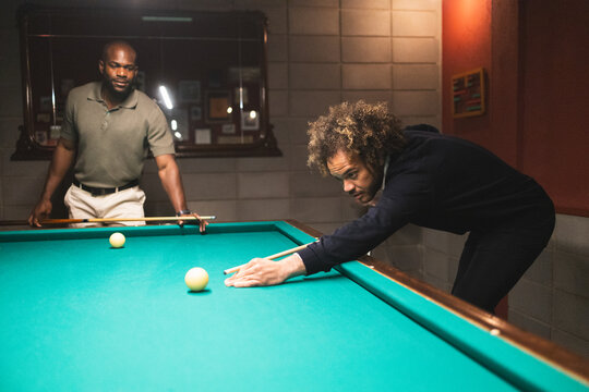 Men playing pool in a coworking space - Powered by Adobe