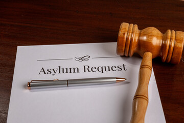Asylum Request Form on Wooden Desk with Gavel – Immigration and Refugee Law Concept

