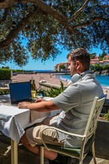 Remote Tech Work by the Sea: Man Using Laptop at Cafe in Sveti Stefan, Montenegro &mdash; Digital Nomad Lifestyle, Cloud Computing, Online Business, Global Connectivity