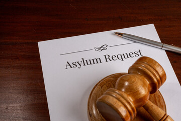 Asylum Request Form on Wooden Desk with Gavel – Immigration and Refugee Law Concept


