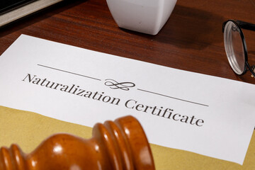 Naturalization Certificate Document on Table with Gavel – Citizenship Law Concept
