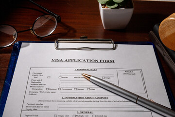 Visa Application Form in Clipboard on Desk – Immigration Document Scene