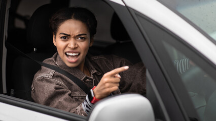 Angry, young, pissed off, displeased, aggressive african american woman shouting on drivers in...