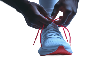 Detailed view of athlete hands fastening shoelaces on running sneakers before exercise isolated on transparent background PNG