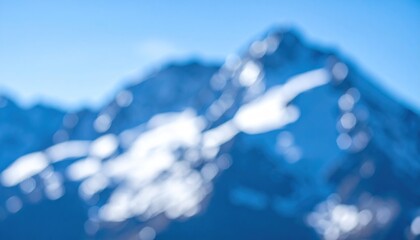 Blurry mountain range, blue tones, snow-capped peaks