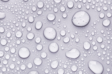 Cosmetic moisturizing liquid drops on grey pastel background. Toner or lotion. Hyaluronic serum