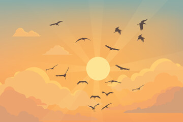 Birds flying across a sunset sky with bright sun and glowing orange clouds.
