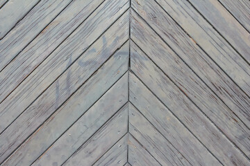 Fototapeta premium Close-up view of gray wooden roof shingles arranged in overlapping chevron pattern showing traditional roofing construction materials