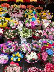 Colorful Assortment of Flower Bouquets at Outdoor Market
