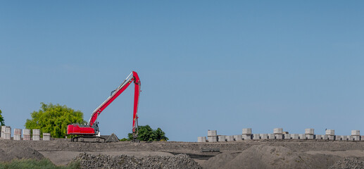 red excavator building new road