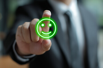Businessman pressing happy face feedback button