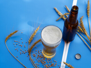 Beer glass on blue table top view.